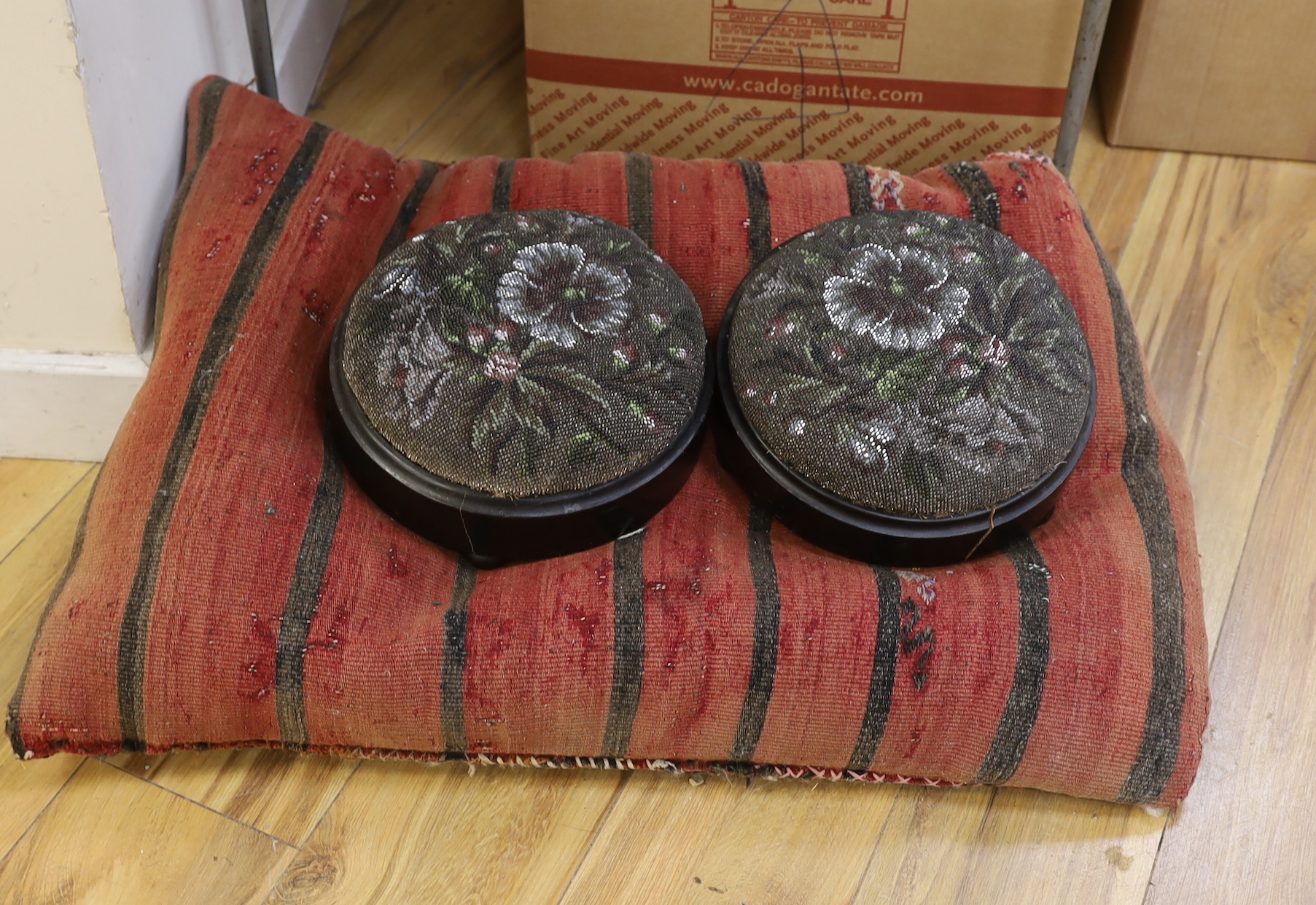 Two floral beadwork foot stools and a large Kilim cushion, the largest 75cm x 55cm